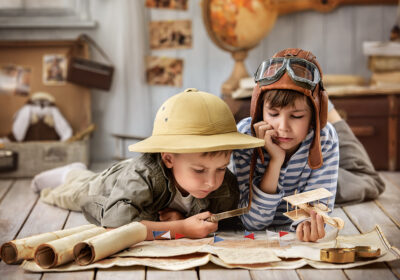 Boys in images traveler and pilot play in his room